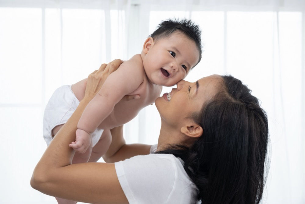 Domestic helper caring for a baby at home
